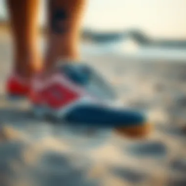 A pair of windsurfing shoes on a sandy beach