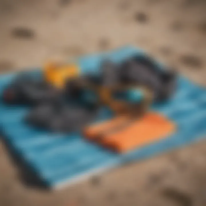 Kitesurfing safety gear laid out on a beach towel