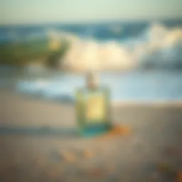 A bottle of Hollister cologne placed on a sandy beach with waves in the background