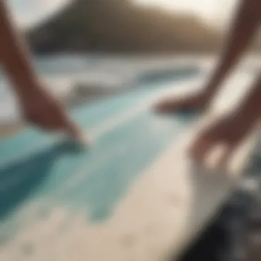 Surfer applying wax to a surfboard for grip enhancement