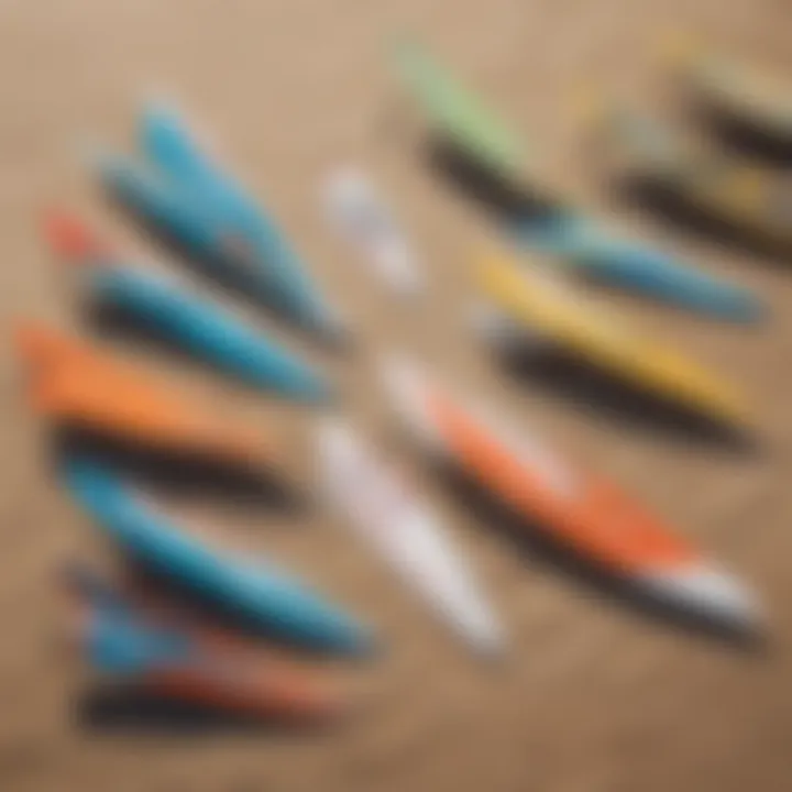 A variety of windsurfing wings laid out on a beach, highlighting different shapes and sizes.