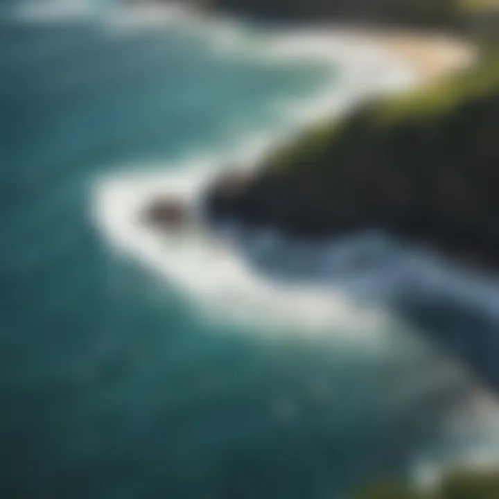 An aerial view of Maui's coastline with surfers scattered across the waves.