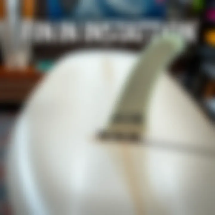 Close-up of FCS II fin installation process on a longboard