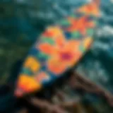 A vibrant surfboard decorated with Hawaiian motifs